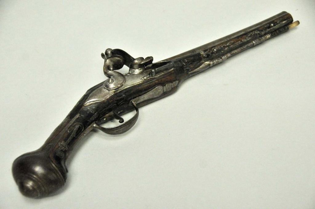 Signed Middle Eastern Flintlock Pistol: Signed on brass top plate; extensive metal string inlay; ornate grip; 15 1/2" with 9" barrel