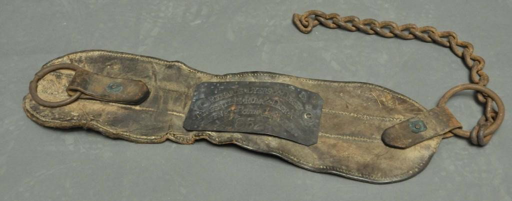 1852 Gaffney South Carolina Slave Collar: Attached metal label "Richards, Byers & Dukes/Turpentine Rum & Dark Niggers/Gaffney South Carolina/1852"; Masonic symbol incised in each corner; not authenticated