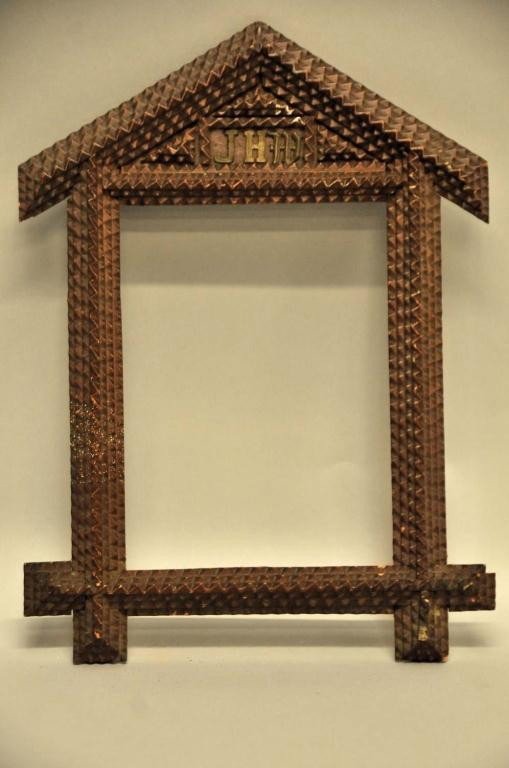 Architectural Tramp Art Frame: Rectangular form having a pediment top with applied gilt metal initials "JHM"; rabbited back; overall 10 1/2"W, 14 14"H; minor losses, scuffs; white paint splatter