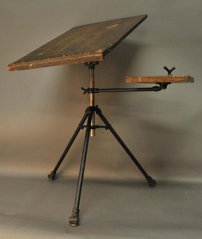 Drafting Table with Side Arm: Adjustable pine drafting table and side arm on metal tripod base; stains and wear to wood commensurate with use and age