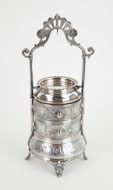 Reed & Barton Silverplate Jewelry Stand: Tiered jewelry stand having a shaped arched crest over an open receptacle, two swivel mid-section drawers and a footed base with receptacle; drawers and base decorated with embossed dog medallions alt