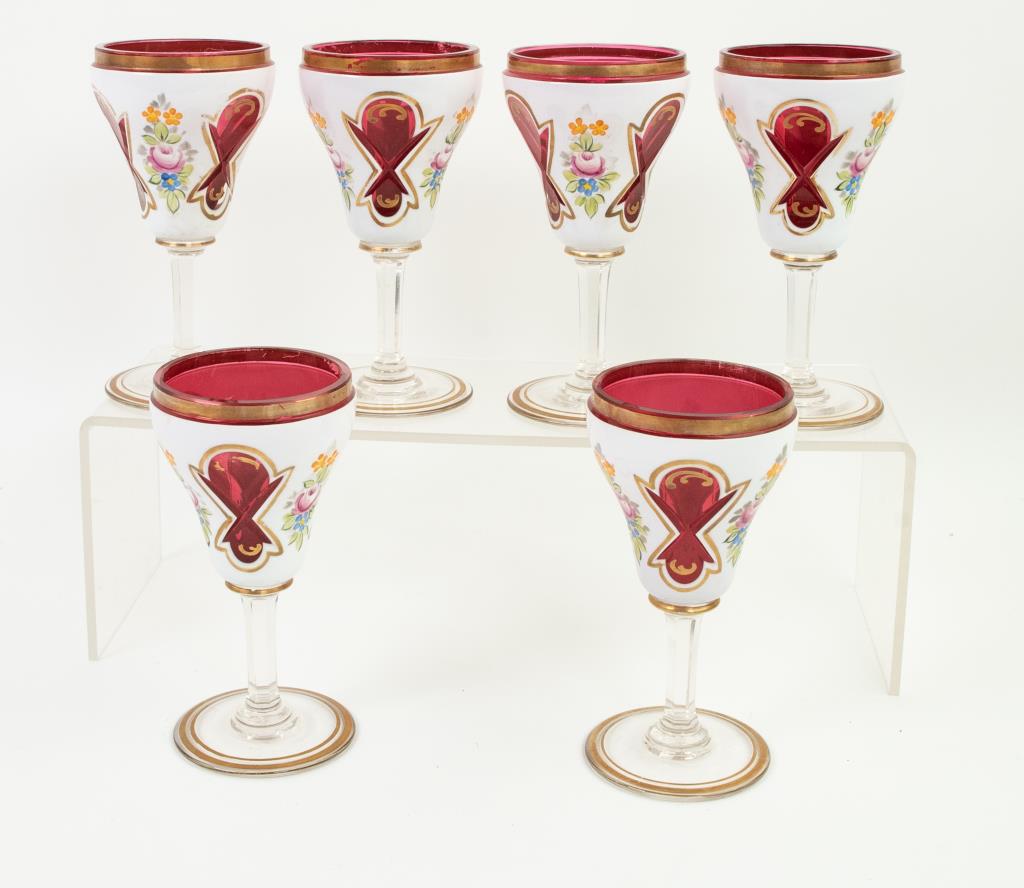 Set of 6 Bohemian Cut to Cranberry Wine Glasses: Set of six Bohemian wine glasses, each having a white ground cut to cranberry and decorated with shaped cranberry panels alternating with hand painted floral bouquets, cranberry rims, each with hexago