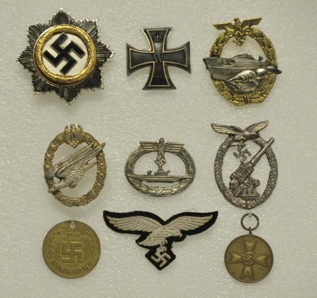 8 WWII German Medals & One Cloth Insignia: Probably all reproductions except war merit medal is possibly period; including German War Merit Medal "Fur Kriegs Verdienst 1939", 1914 Iron Cross, Paratrooper Badge, Luftwaffe Nazi Flak Artillery Ba