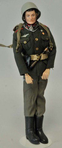 G.I. Joe German Soldier Action Figure: c. 1966; black painted hair and blue eyes; wearing helmet with decals, jacket, pants, boots, Iron Cross medal around his neck, pistol and holster on canvas belt, grenade, field pack; minor rubs to hai