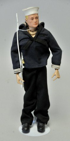 G.I. Joe Sailor Action Figure w/ Scar: c. 1964 sailor with dog tag and scar on right cheek; blonde hair with brown eyes; wearing V-neck shirt with collar and knotted tie in navy with white trim on cuffs and collar; navy pants; white sailor