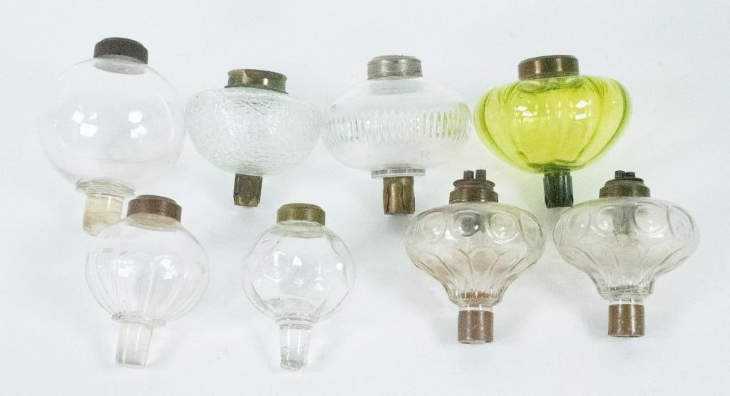 Eight Whale Oil / Fluid Peg Lamp Fonts: 1. Pair of clear blown molded fonts having a medial band of twelve bulls' eyes or punties over a band of twelve flutes at base, pegs with brass sleeves, each with double tube burners; approx. 3 1/2"W,