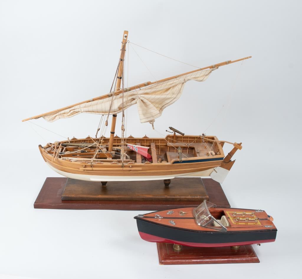 2 Wood Model Boats--Gunboat & Speed Boat: 1. Gun boat with single sail, three mounted cannons, oars, British flag, anchor, barrels and other equipment; 25"L, 22"H, 8"W---2. Inboard speed boat mounted on stand; 14"L, 5 1/2"H, 4 3/4"W---both in