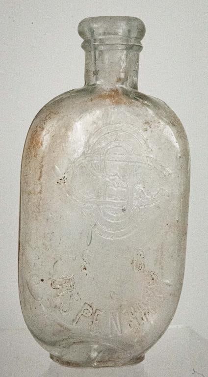 South Carolina Dispensary JoJo Flask: 1/2 pint clear monogrammed JoJo flask manufactured by C.L.F.G. Co. as embossed on bottom; #112 of "The South Carolina Dispensary A Bottle Collector's Atlas and History of the System" by Phillip Kennet