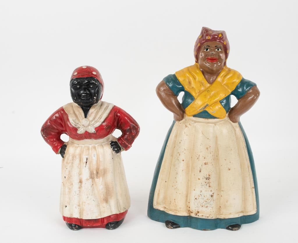 2 Mammy Cast Iron Figural Doorstop / Bank: Two painted cast iron Mammy figures, each standing with hands on hips, probably late 20th century: 1. Doorstop, wearing blue dress with traditional apron and scarf, interior marked "CN"; 8"W, 13"H---2