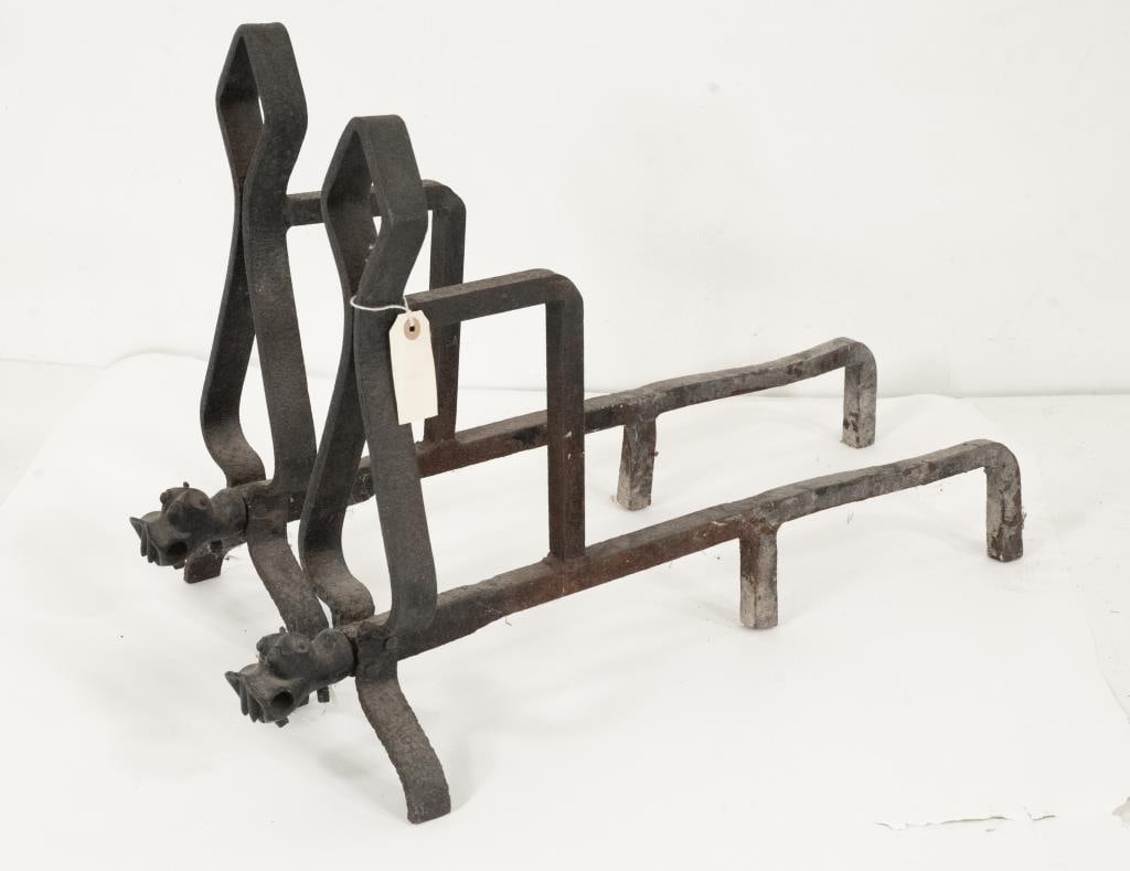 Pair of Hippopotamus Head Andirons: Pair of wrought iron andirons, upright formed as a rounded diamond shape over a rounded and longer triangle shape with the figural head of a hippopotamus at the base; 17 3/4"H, 7 1/2"W, 28 1/4"D; some