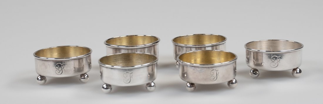Set of 6 Tiffany Sterling Salt Cellars: Round with ball feet, each marked "Tiffany & Co / 3403M6149 / Sterling-Silver", each engraved with initial "F" or possibly "T"; 1 1/2"W, 3/4"H; minor dents to bottoms, two with heavy salt etching to b