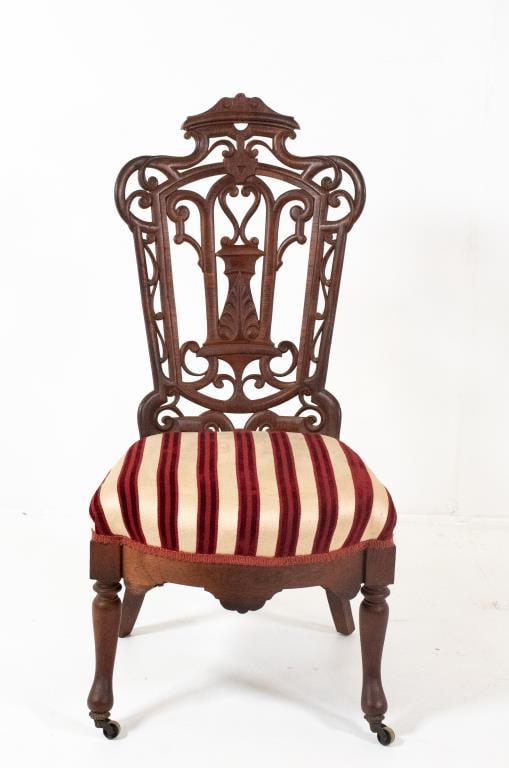 19th C. Laminated Rosewood Slipper Chair: In the manner of Belter or Meeks, carved crest over a pierced and carved shaped back, shaped legs with casters; 18 1/2"W, 38 1/2"H, seat 15"H---good condition with light soiling to seat upholstery, sm