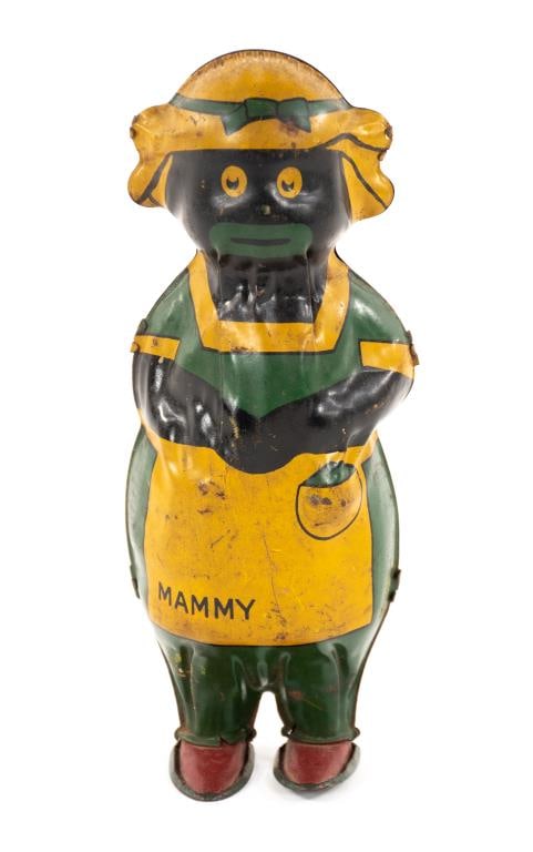 Lindstrom Tin Litho Mammy Wind-Up Toy: Depicting an African-American woman wearing an apron marked "MAMMY", figure dances back and forth when wound; 7 3/4"H---Condition: good overall condition with some light scratches, scuffing and slight