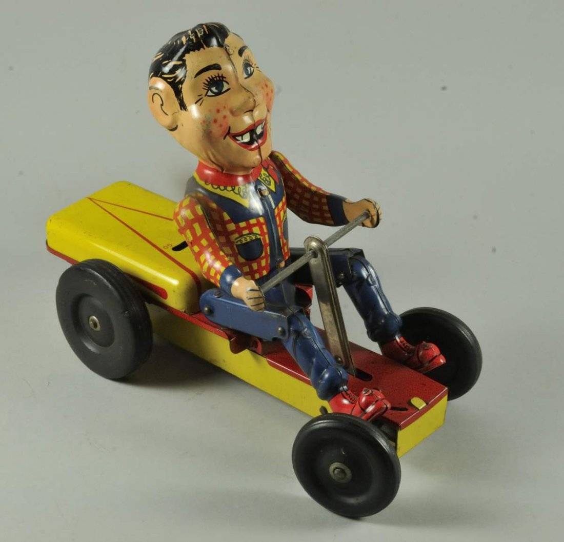 Tin Ny-Lint Pump-Mobile Wind-Up Toy: American tin litho with rubber wheels, cowboy figure looks similar to Howdy Doody, made by Ny-Lint Toys; 8 1/2"L; very slight wear to paint