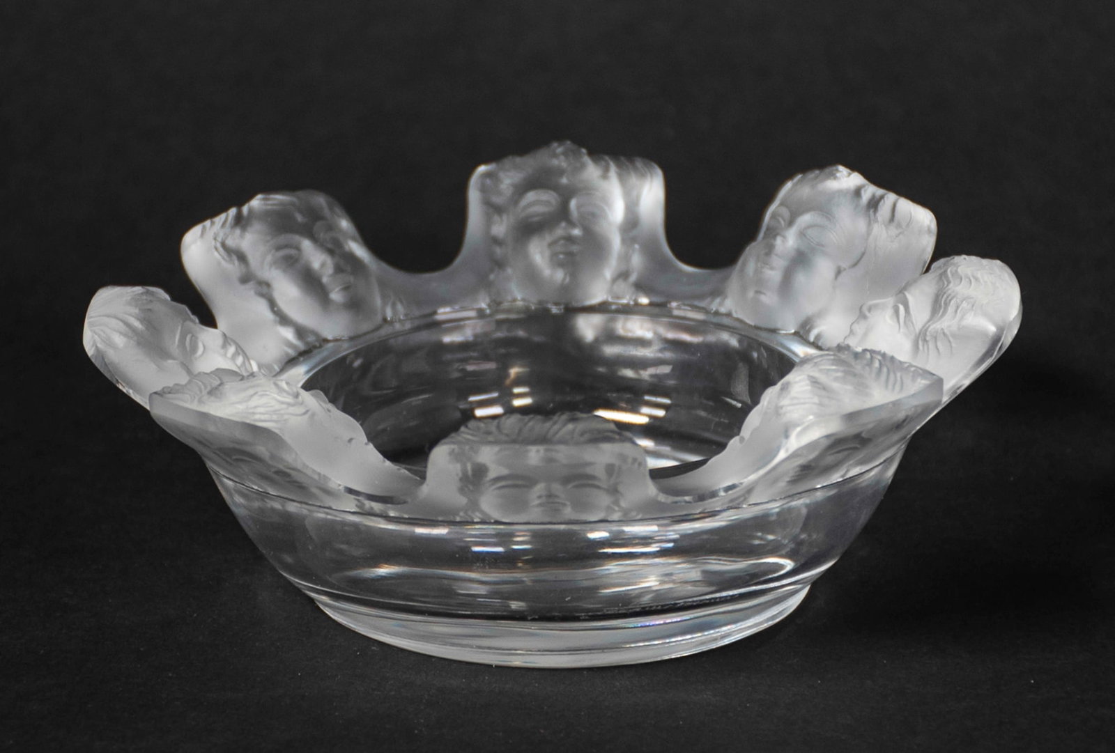Lalique "St. Nicholas" Cherub Crystal Dish: Rim with eight cherub faces, etched on base "Lalique France"; 4 3/8"W, 1 1/2"H; good condition (Inv. 18)