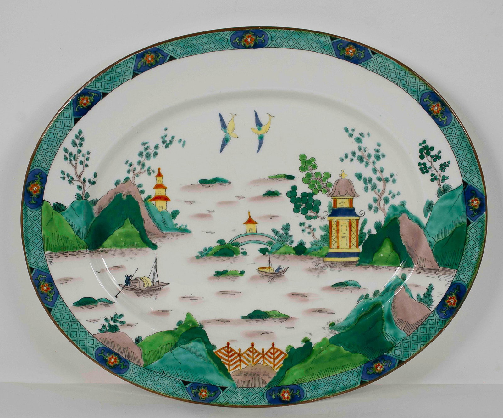 Crown Staffordshire Chinese Willow Platter: 15"W x 12 1/4"H platter in the "Ye Olde Willow" or "Chinese Willow" pattern by Crown Staffordshire, England; Chinoiserie pattern depicting an Asian scene with pagodas, boats and birds in a colorful la