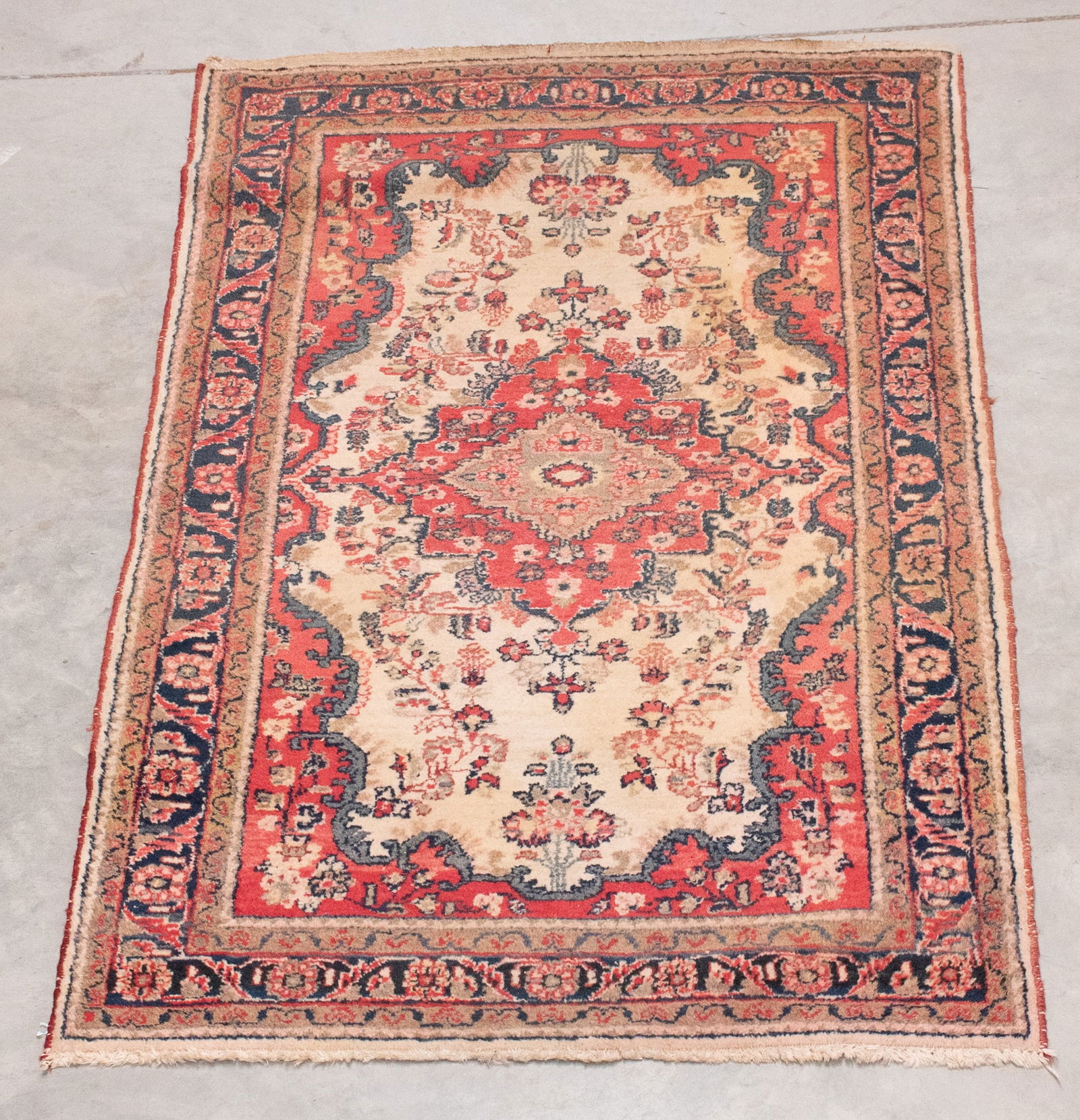 Persian Rug, 4'2"W, 6'8"L: Coral medallion on ivory ground; tan, green and coral flowers; "Made in Iran" tag; 4'2"W, 6'8"L; some scattered wear (Inv. 65)