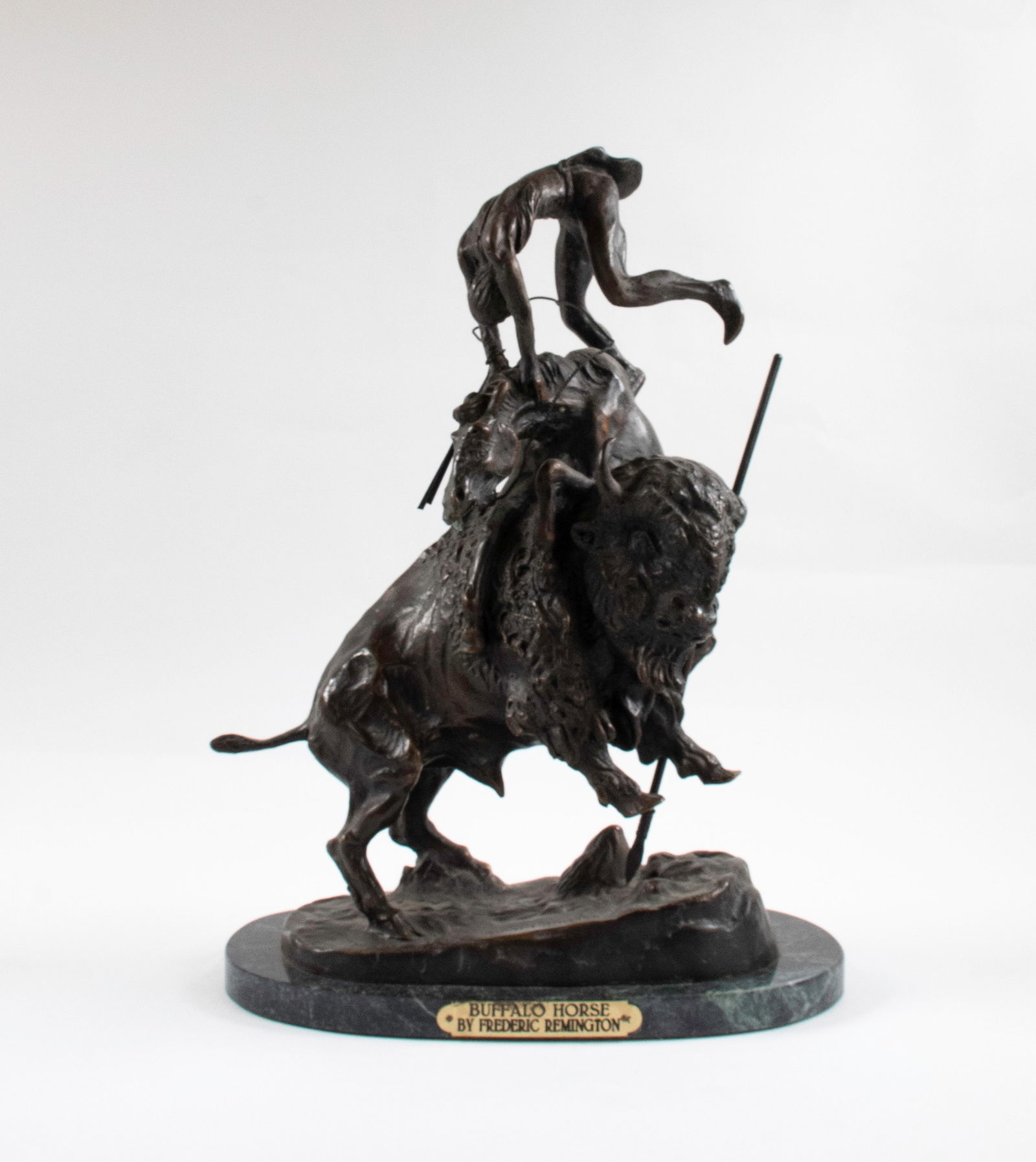 After Frederic S. Remington, Bronze Buffalo Horse: Patinated cast bronze, "Buffalo Horse" after the original by Frederic S. Remington (American, 1861-1909), signed "Frederic Remington" in the casting base, mounted on an oval variegated green marble ba