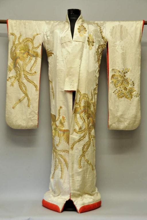 Japanese Embroidered Silk Kimono: 20th century, ivory silk body elaborately embroidered in gilt thread with highlights in silver metallic and polychrome silk threads, overall design of large birds and flowers, lined in red silk, padde