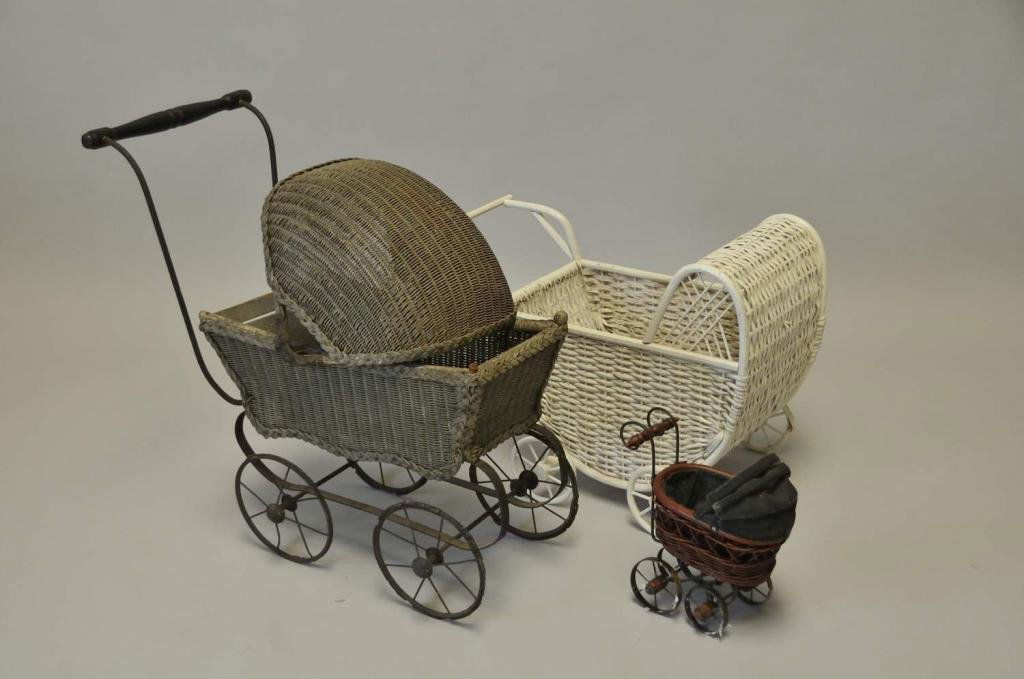 Three Doll Carriages: 1. Late 19th/early 20th century wicker doll carriage with metal wheels, 23"H; 2. 20th century white wicker doll carriage, 16"H; 3. 20th century miniature doll carriage; wicker, metal and cloth constru