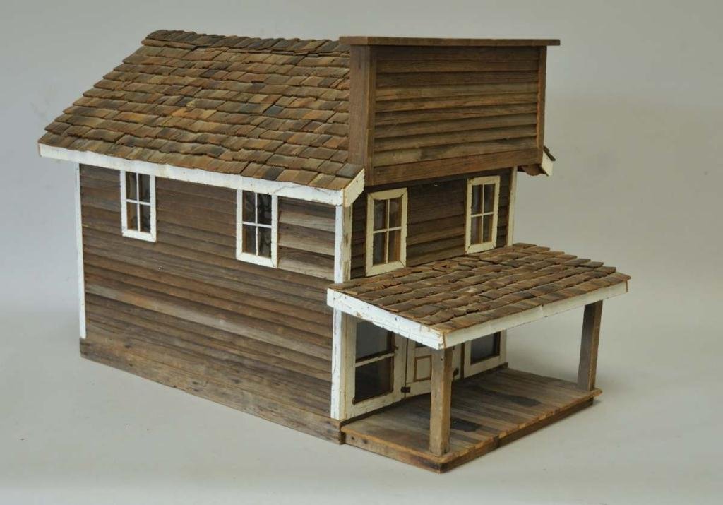Folk Art Saloon or Frontier Style Building: Hand crafted wooden house with individually applied shake shingles, covered front porch with double doors, roof lifts to reveal attic and attic floor can be lifted to reveal first floor; 25 1/2" x 15 