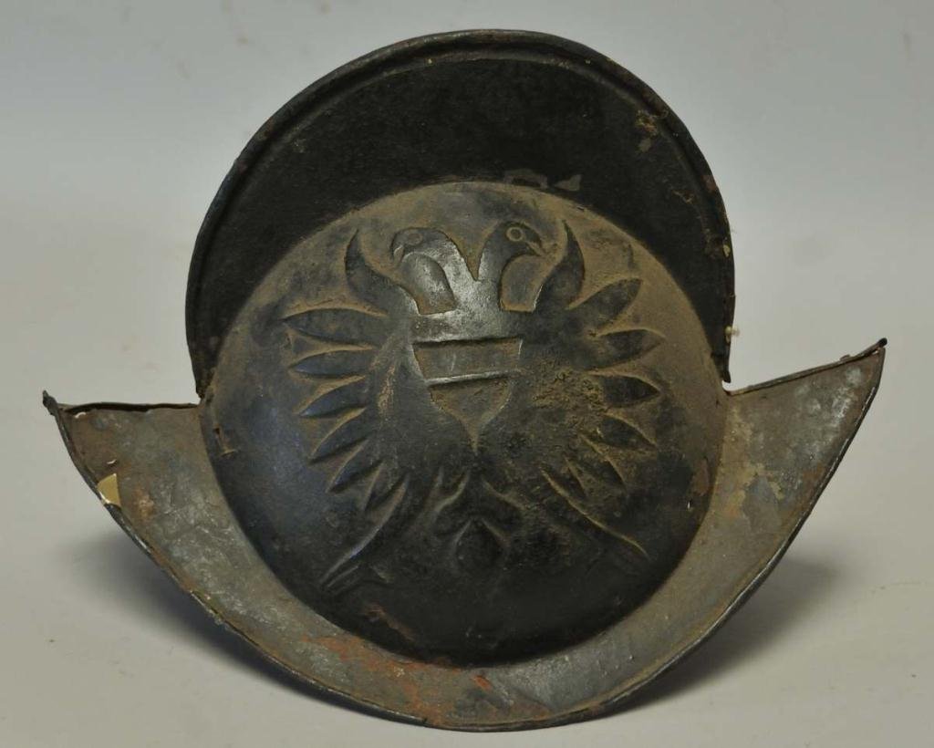 Conquistador Helmet with Double Headed Eagles: Heavy metal conquistador helmet having an embossed double headed eagle each side and lining rivet holes, probably 17th century or earlier, discovered by consignor in a barn in Lithuania in the early 1