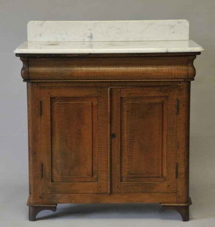 19th Century Tiger Maple Cabinet: Ogee drawer over two paneled doors; drawer with cut nail construction, case with pegged construction; pine secondary; later marble top with backsplash; 33 1/4"W, 17"D, 36"H--From the estate of Thomas 