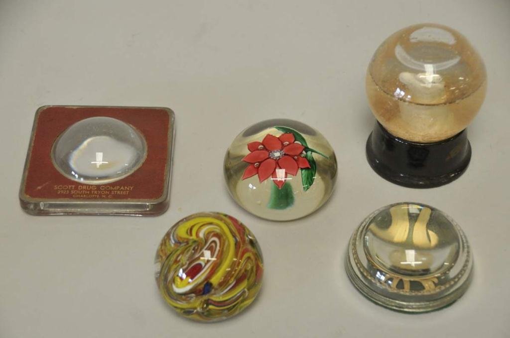 Four Paperweights & Snow Globe: 1. Advertising magnifying glass paperweight, "Scott Drug Company / 2923 South Tryon Street / Charlotte, N.C."; 2. Swirled paperweight, made in India; 3. Floral paperweight centered with a large flower