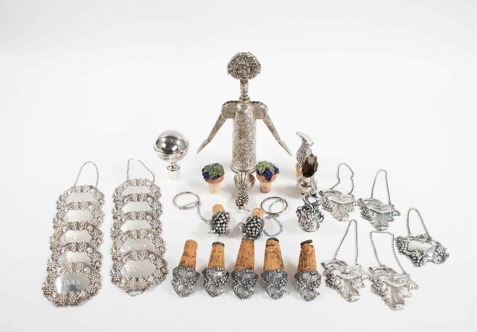 Figural Corkscrew, Liquor Labels, Stoppers: Bacchus" figural silverplate corkscrew, by Godinger Italy; 9"H---Set of ten silverplate liquor decanter tags having repousse grapevine borders: PORT, VODKA, BRANDY, BOURBON, COGNAC, WHISKEY, SCOTCH, S
