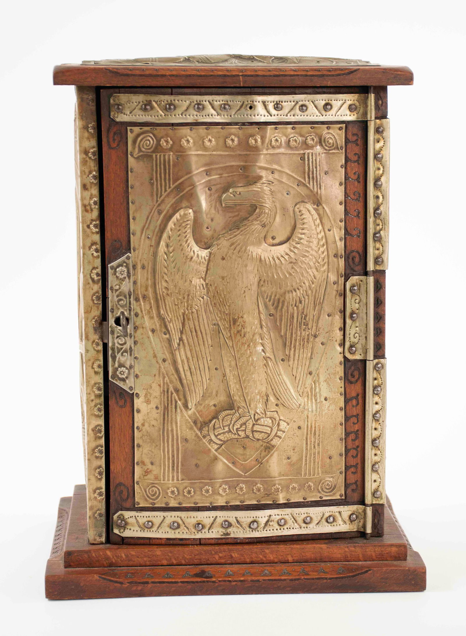 French Table Top Pharmacy Cabinet: Carved walnut pharmacy cabinet with embossed brass panels to all sides; top with embossed dragon panel, door and back with embossed eagle panels, each side with embossed fleur-de-lis panel; door