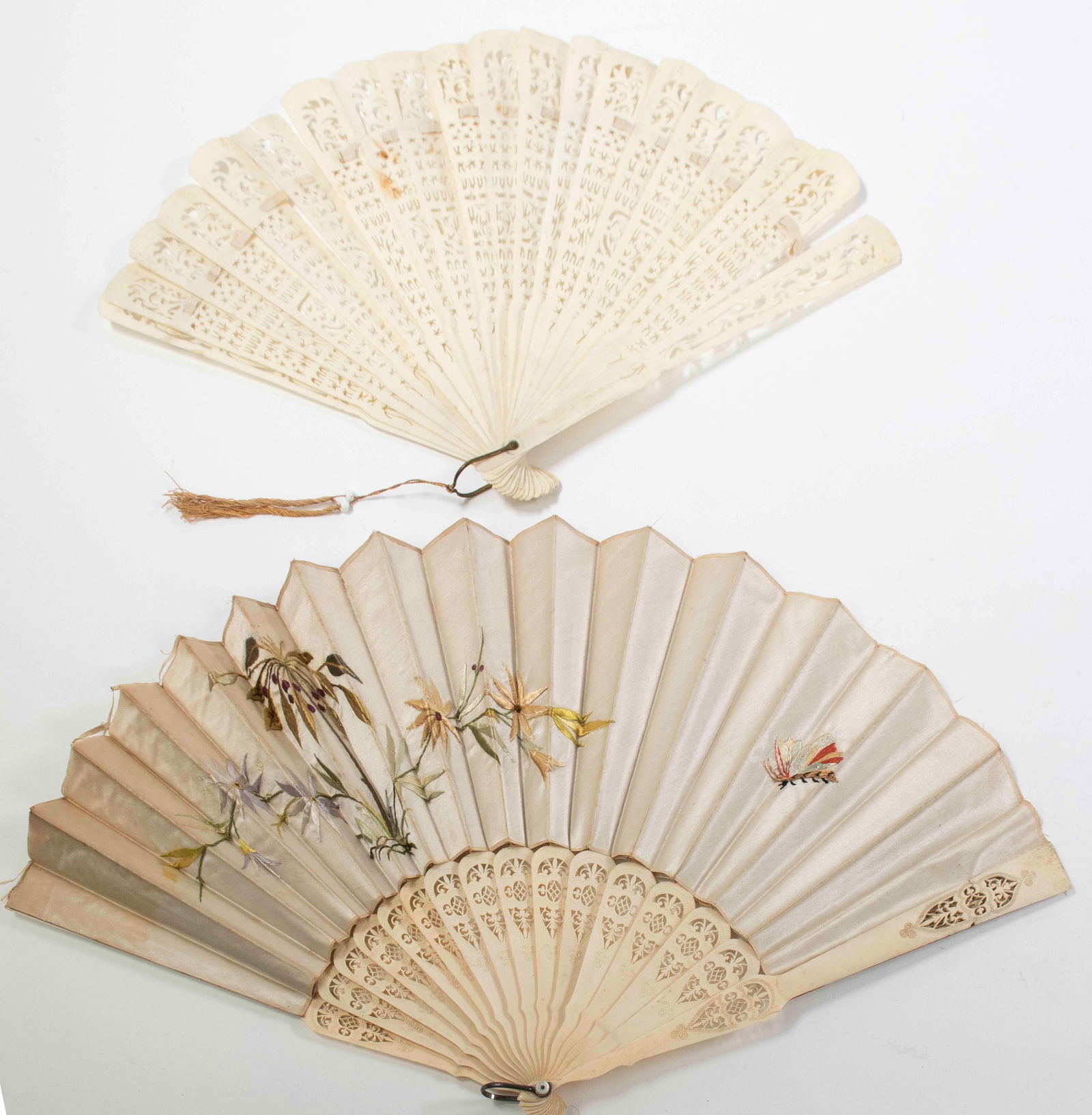 Chinese Embroidered Silk & Carved Bone Fans: 1. Silk fan embroidered with a butterfly and flowering bamboo, sixteen intricately carved and pierced sticks; 11 1/8"L; one guard with horizontal crack and minor chip at one side of crack, some wear a