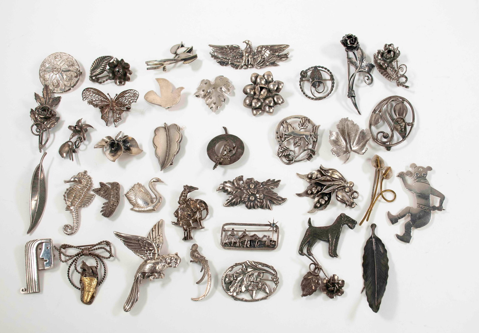 36 Sterling Brooches: All marked for sterling; other marks include Wells, Stuart Nye, Ward Bros, Hand Made, Germany, Jewelart, GFMW, Inc.---total weight 11.62 ozt (Inv. SJ-19)