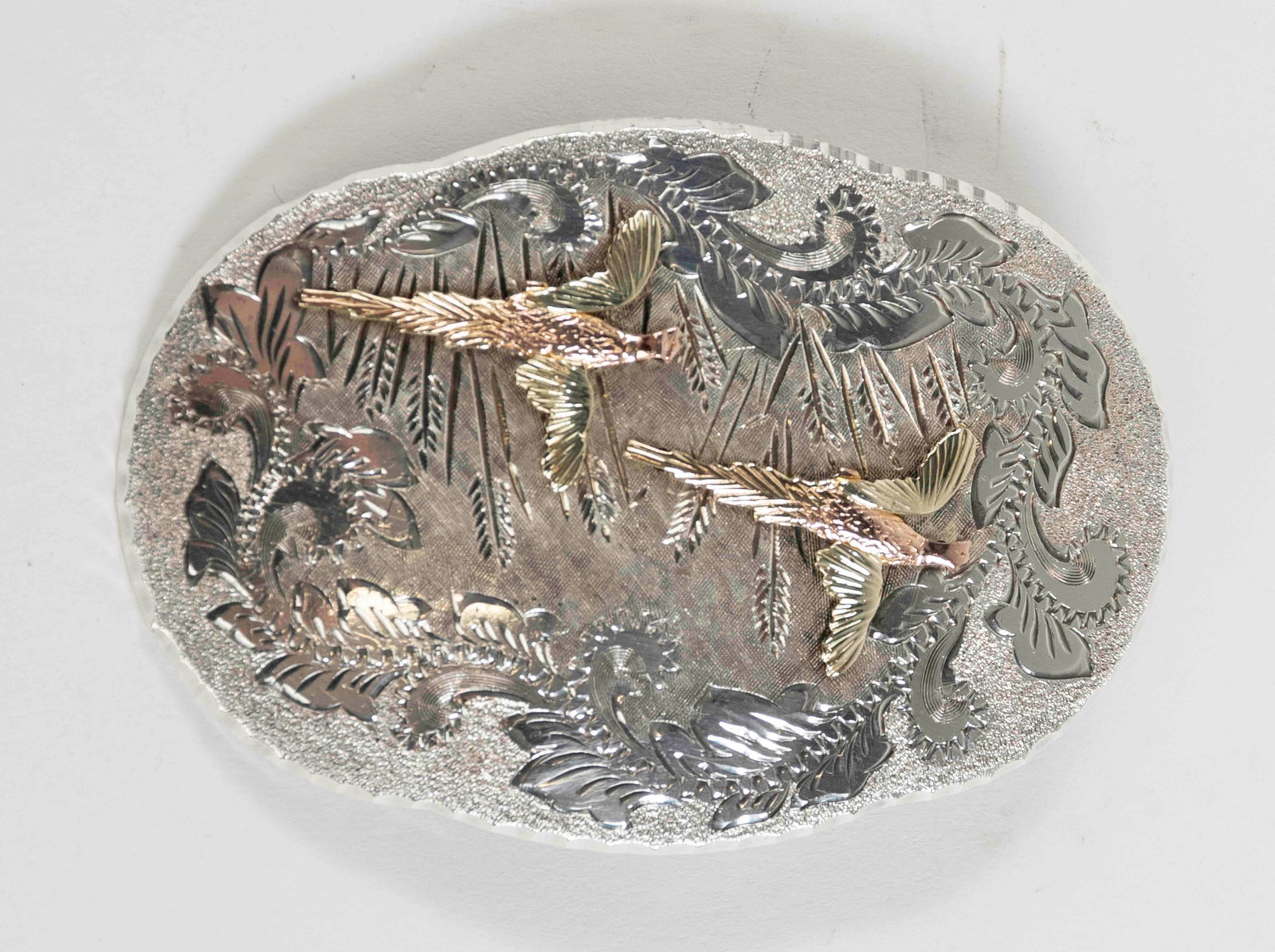 Landstrom's Black Hills Sterling/10K Belt Buckle: Vintage Landstrom's, Black Hills, South Dakota, belt buckle; depicting embossed rose and yellow gold pheasants in flight over an etched background; back of buckle marked "BHJCO L / Sterling Silver / 1
