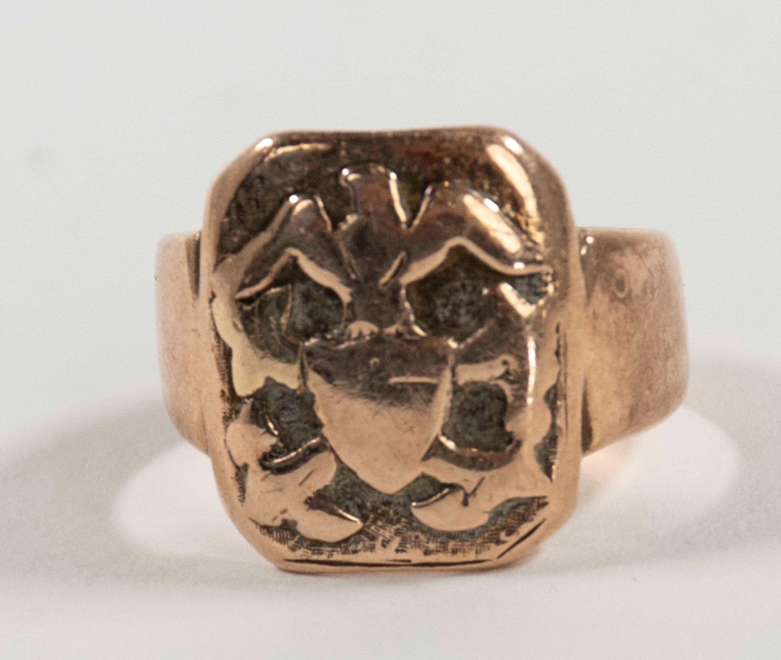 9 ct. Yellow Gold Signet Ring: Head of ring with eagle perched atop a shield with crossed arms, marked "9 ct' in rectangle; size 6 1/2---6.95 grams (Inv. 2)