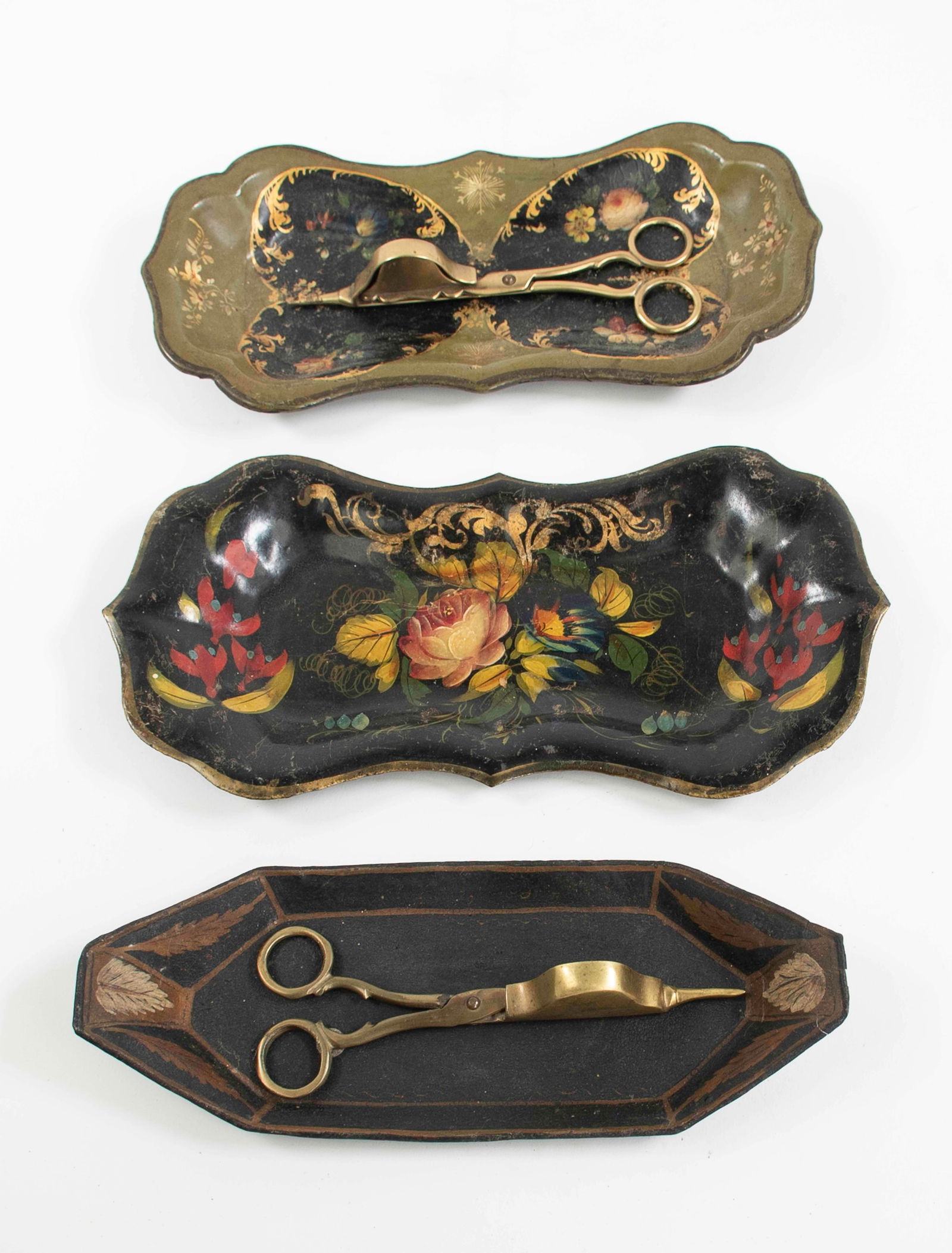 3 Painted Tole & Papier Mache Snuffer Trays: 1. Shaped oval painted tole tray, black with polychrome floral decoration, with brass Virginia Metalcrafters / Colonial Williamsburg candle trimmers; 10 1/2"L---2. Octagonal painted tole tray, black