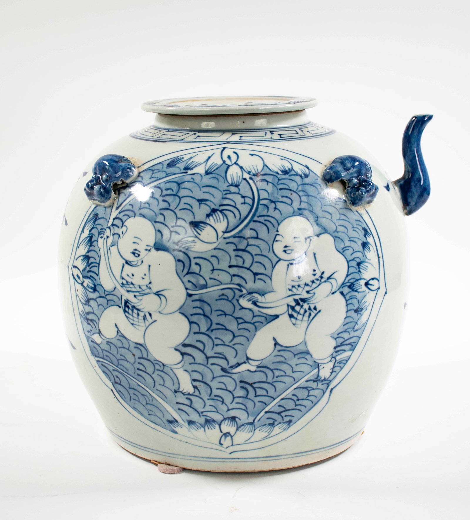 Chinese Blue & White Porcelain Water Jug: Covered water jug, shoulder with dog head handles, decorated front and back with medallions of children playing in a pond with fish scale pattern background and water lilies, floral decoration each