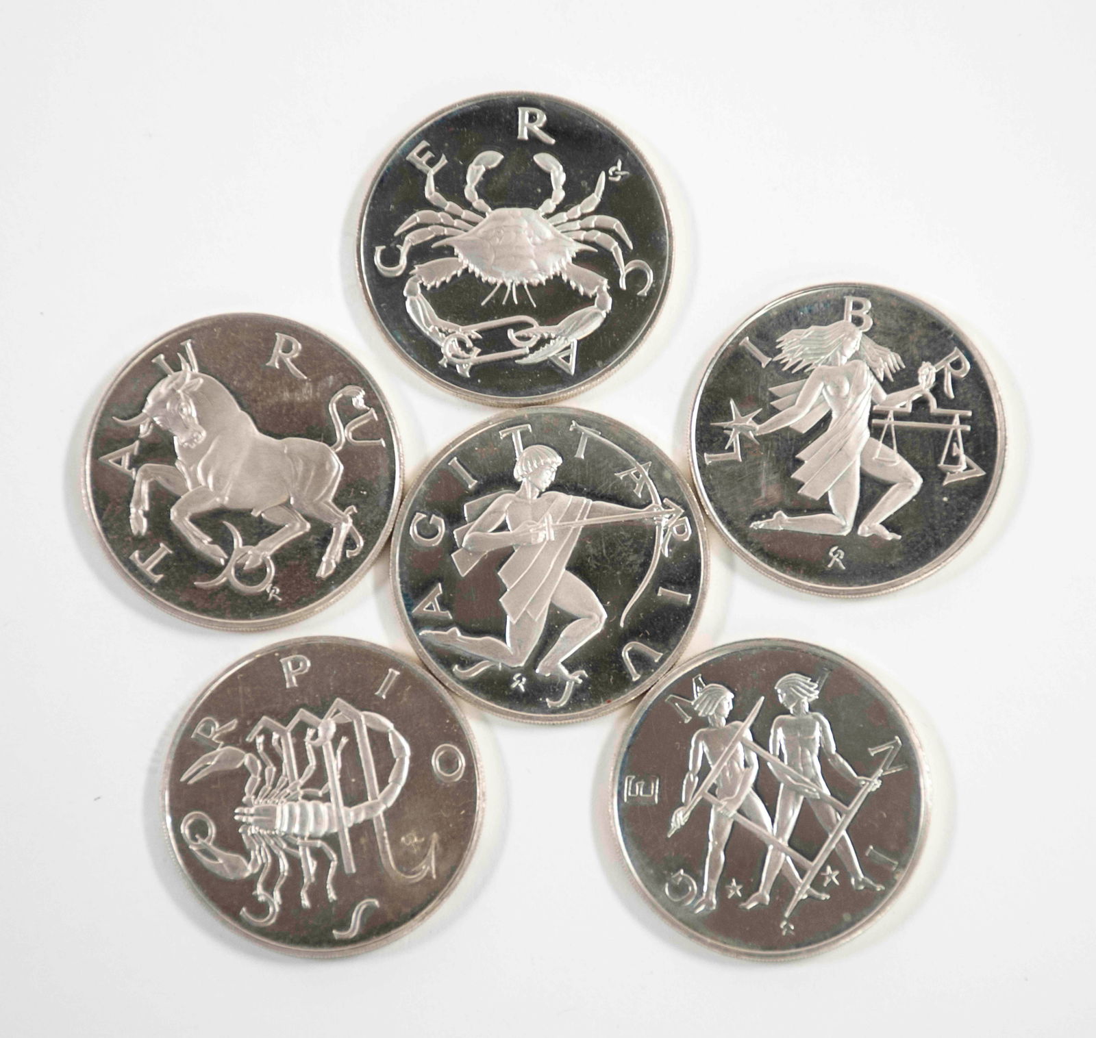 6 Sterling Silver Franklin Mint Zodiac Medals: c. 1968, six sterling silver 1 1/4" diameter Franklin Mint Treasury of Zodiac medals: Taurus, Gemini, Cancer, Libra, Scorpio, Sagittarius; each marked around edge "Sterling FM 68 P"; good condition---