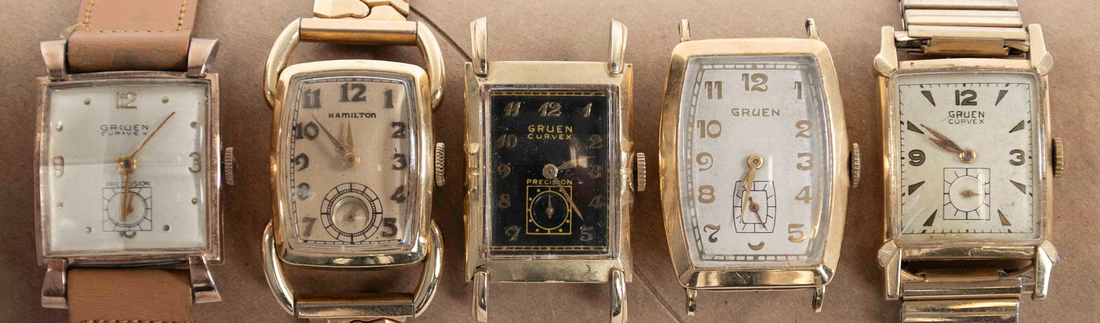 Five Vintage Gentlemen's Watches: 1. Gruen Curvex, 10K gold filled---2. Gruen, 10K gold filled---3. Gruen Curvex Precision, 10K gold filled, black face---4. Gruen Curvex Precision, 10K gold filled, white face---5. Hamilton, 14K gold f