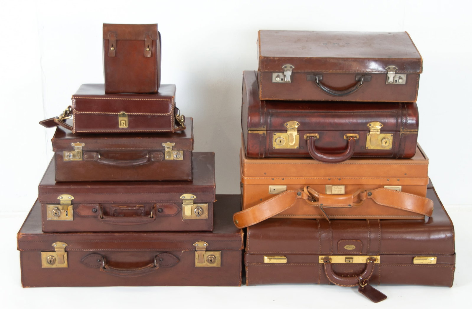 Vintage Leather Suitcases & Shoulder Bags: Seven vintage leather suitcases and two leather shoulder bags; suitcases include one Hartmann Luggage light brown leather with paisley patterned interior lining, one Maximillian (New York), one Britis