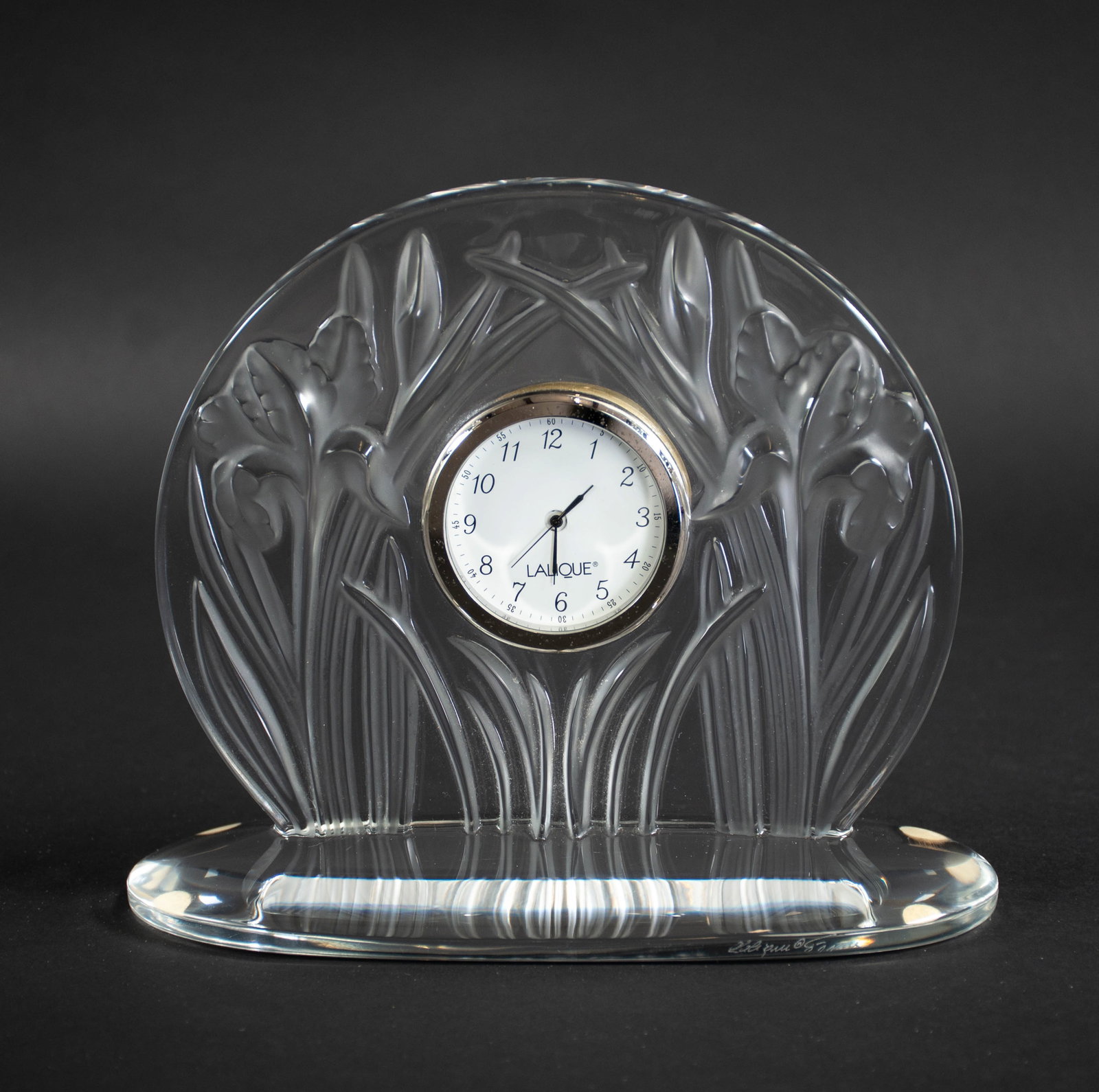Lalique "Iris" Crystal Mantle Clock: Qualifies for in-house shipping---Clear and frosted iris motif in relief, signed on front edge "Lalique France", face of clock also marked "Lalique"; approx. 6 3/4"H, 8"W, 3 1/2"D---From the estate of