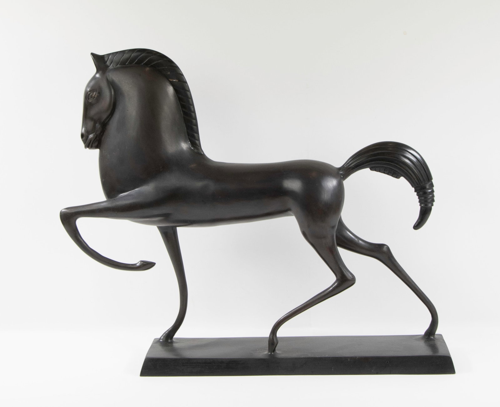 Style of Boris Lovet-Lorski: Qualifies for in-house shipping---Sculpture of an Etruscan horse with one leg raised, in the style of Boris Lovet-Lorski (1894-1973), rectangular base, bronze patinated brass; approx. 22"L, 18 1/2"H, 