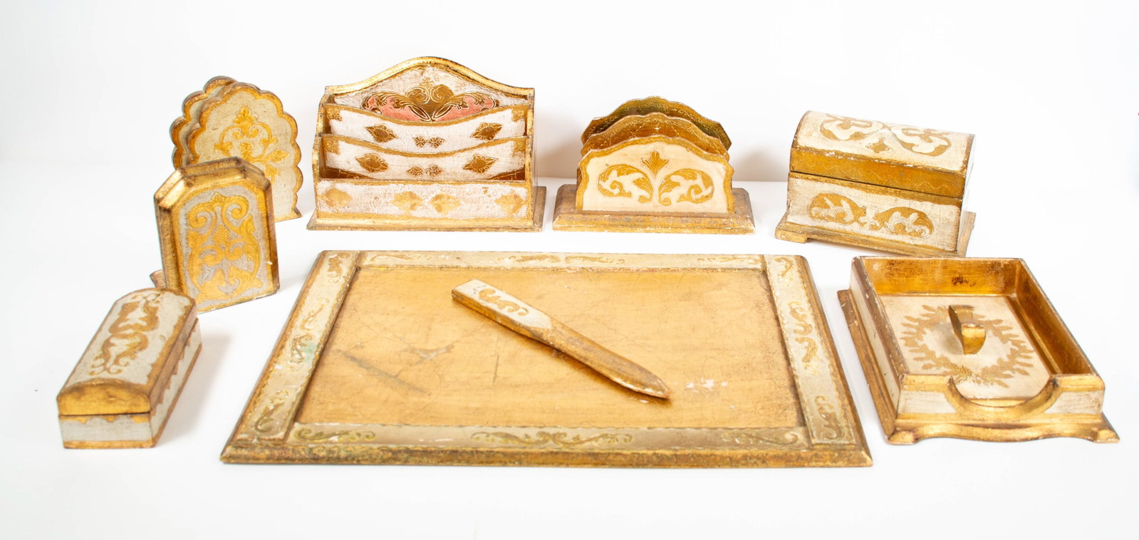 Ital. Florentine Carved Gilt Wood Desk Accessorie: Qualifies for in-house shipping---Lot of Italian Florentine carved gilt wood desk accessories, including: Desk pad or blotter; 19 3/4"W, 13 3/4"H---Letter opener; 10 1/2"L, 1 1/4"W---Two letter holder