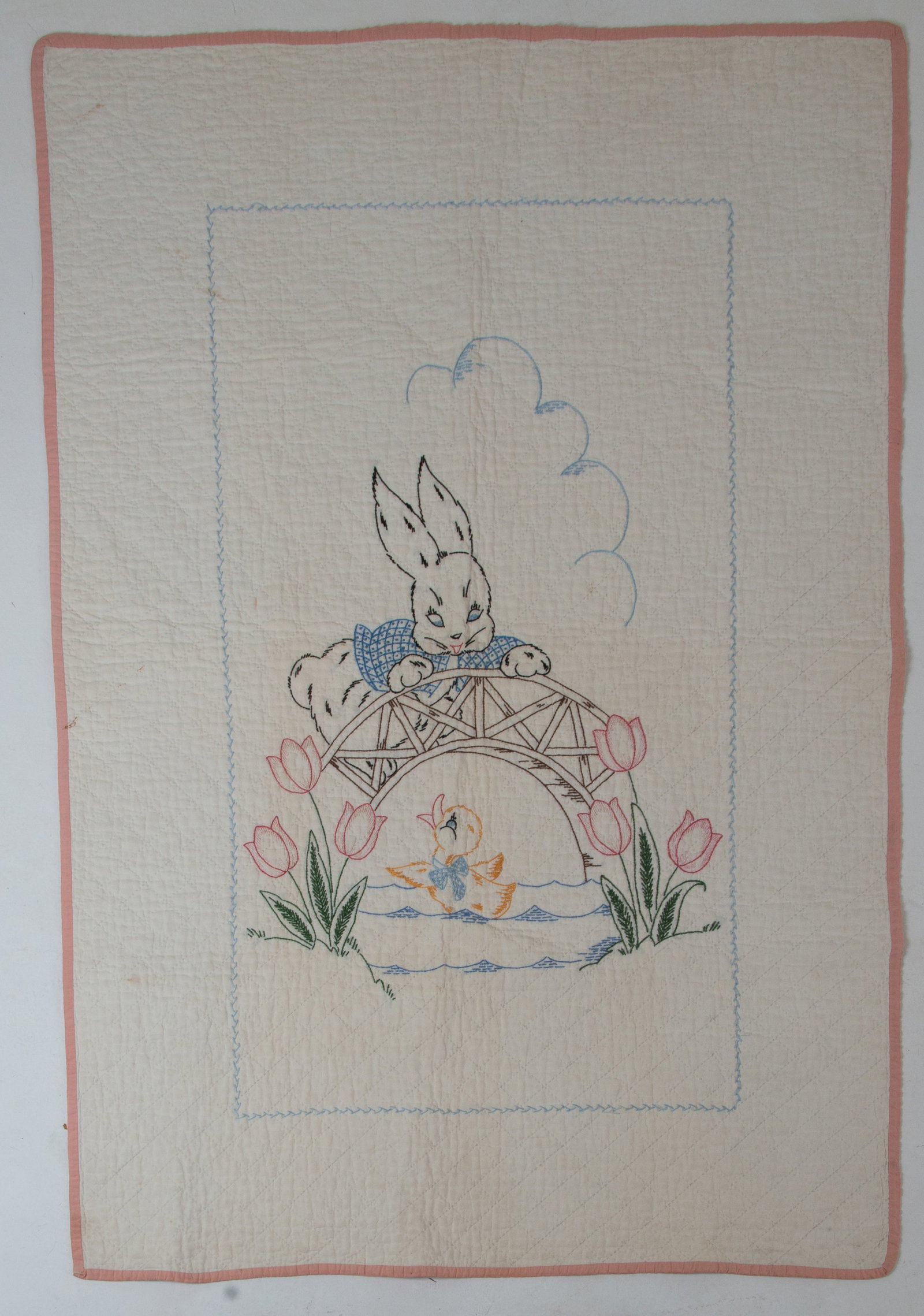 Antique Embroidered Crib Quilt: Qualifies for in-house shipping---Depicting a rabbit standing on a bridge and watching a duckling swim below with tulips on each side of water; pink binding, diamond pattern quilting; 46"L, 32"W;