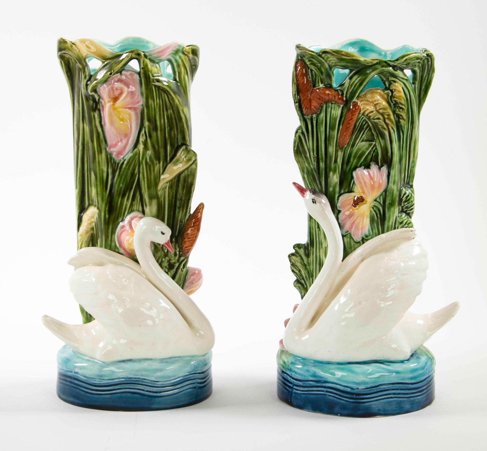 Pr. Continental Majolica Swan Figural Vases: Qualifies for in-house shipping---Pair of majolica vases with full-bodied swan figures against a backdrop of cattails and irises; one base impressed "11692 / 32" and with handwritten "17" in black,