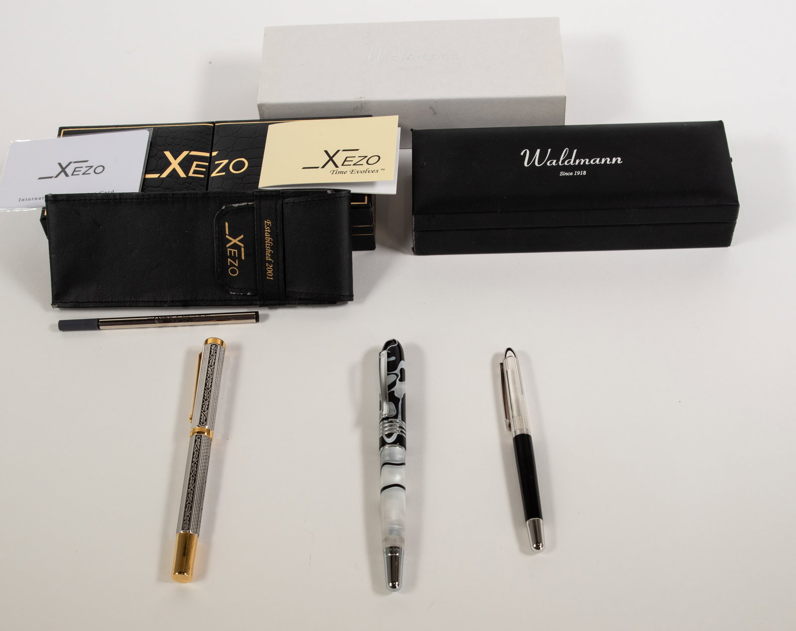 Two Fountain Pens & Ltd. Ed. Rollerball Pen: Qualifies for in-house shipping---Waldmann sterling silver fountain pen, black barrel with a ribbed sterling silver cap having a blank rectangular cartouche for monogram or name, nib marked "M