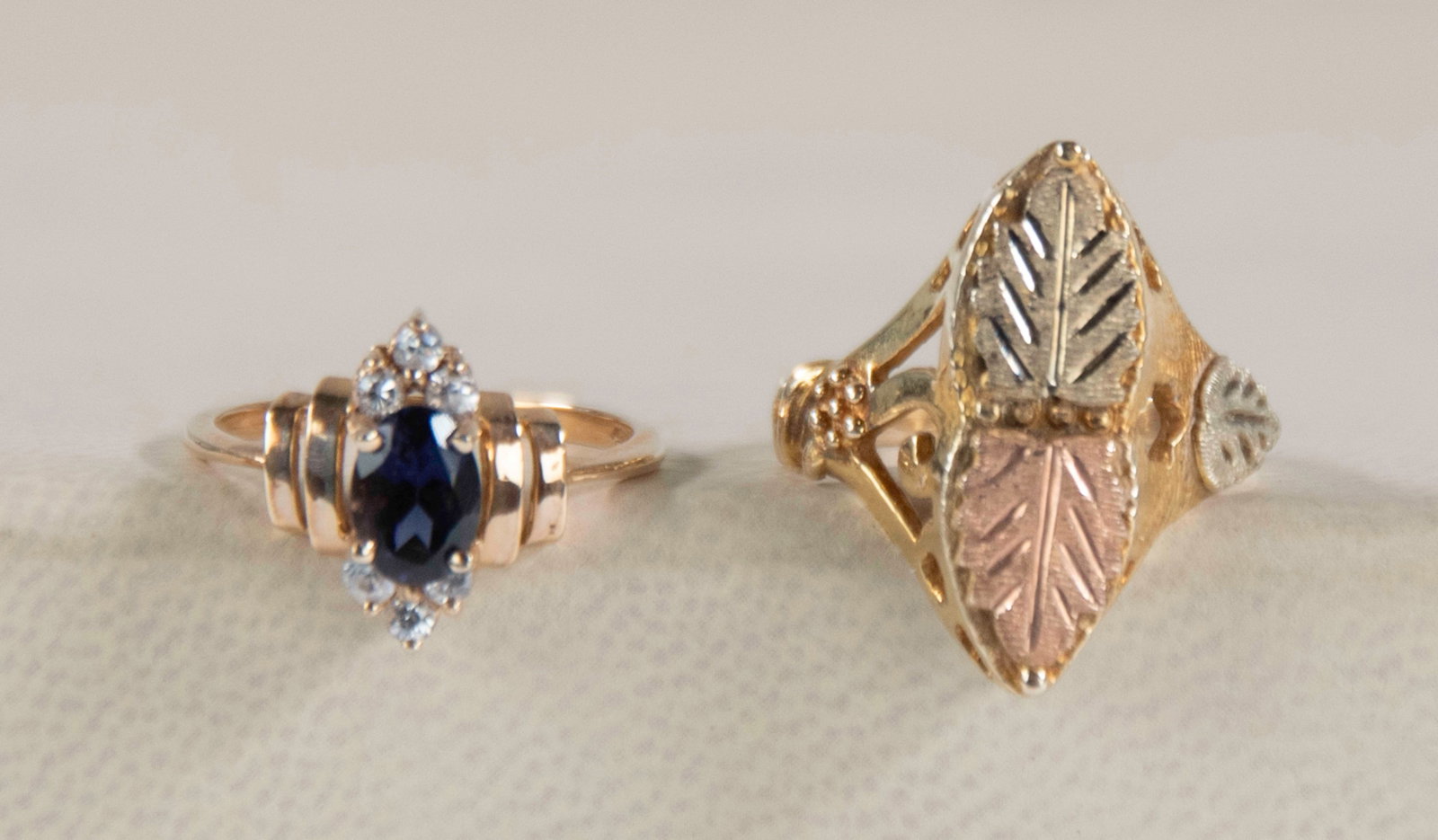 Two 10K Gold Rings---Black Hills & Other: Qualifies for in-house shipping---1. 10K handcdrafted ring with tri-color design including a 10K yellow gold base with green and rose leaves and openwork gallery, marked "RGC 10K", Mount Rushmore Blac
