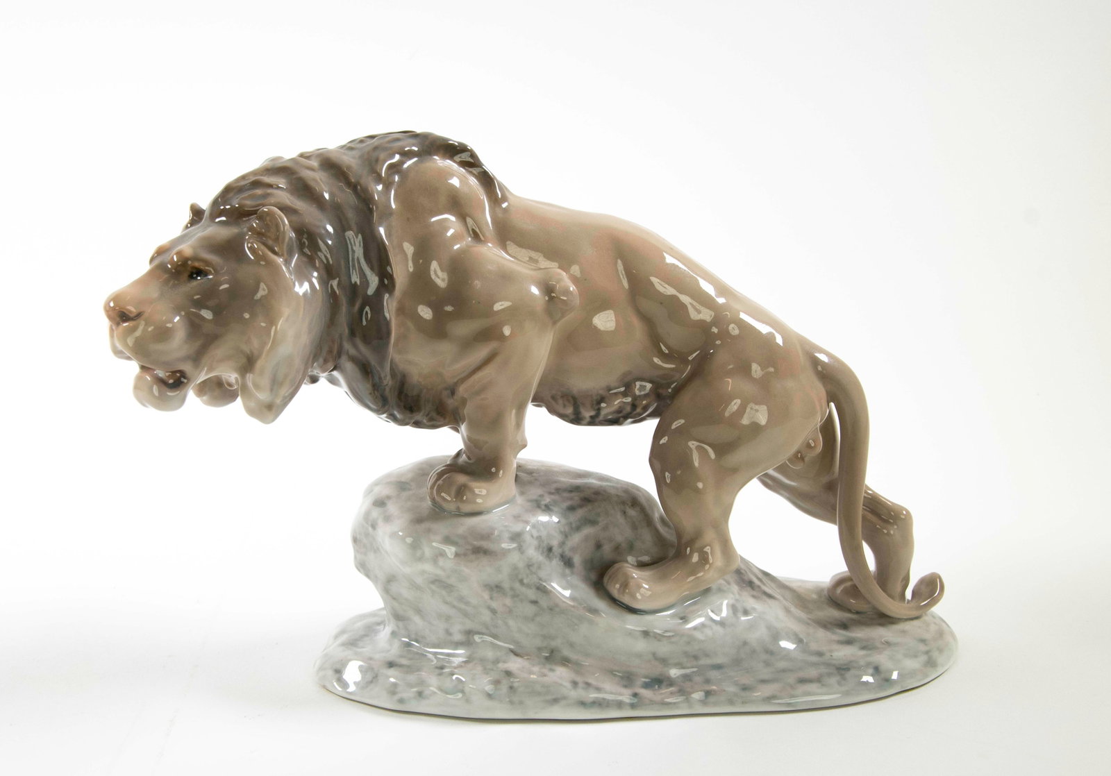 Large Bing & Grondahl Porcelain Lion: Qualifies for in-house shipping---Large porcelain figure of lion standing on a stone, made in Denmark, No. 2057; approx. 12"L, 4 1/8"W, 8"H; good condition---From the estate of Dr. Anthony Lenti and