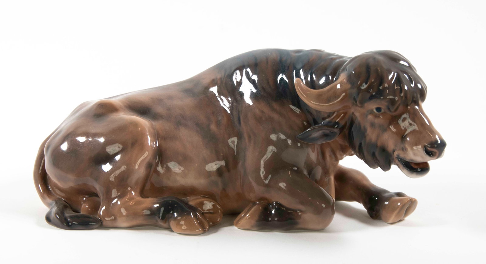 Dahl Jensen Porcelain Water Buffalo: Qualifies for in-house shipping---Recumbent figure of a water buffalo, No. 1256, marked on undersdie with Royal Crown and "DJ Copenhagen"; 11 1/2"L, 4 1/2"H; good condition---From the estate of Dr.