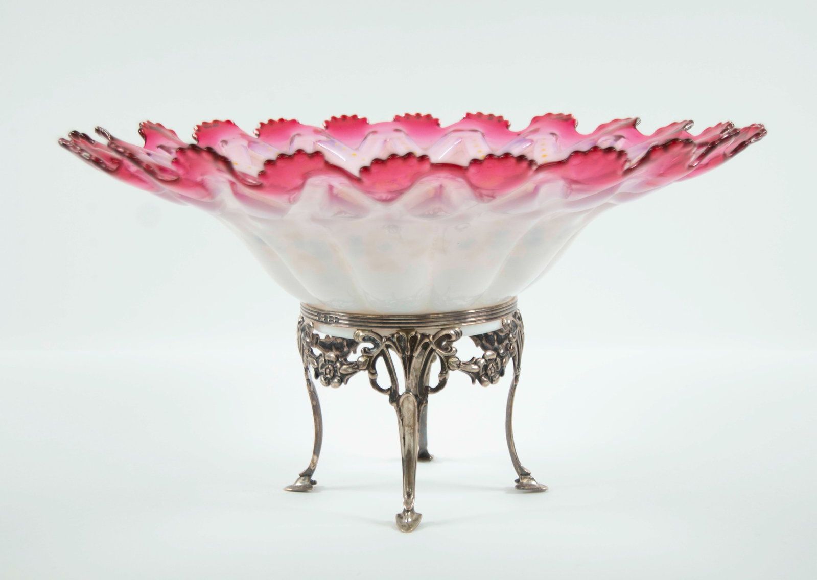 Bride's Bowl on Sterling Silver Stand: Qualifies for in-house shipping---Unusual art glass cranberry cased bridal bowl, round bowl with cranberry scalloped rim centering a molded interior accented with raised enamel beading and floral swag