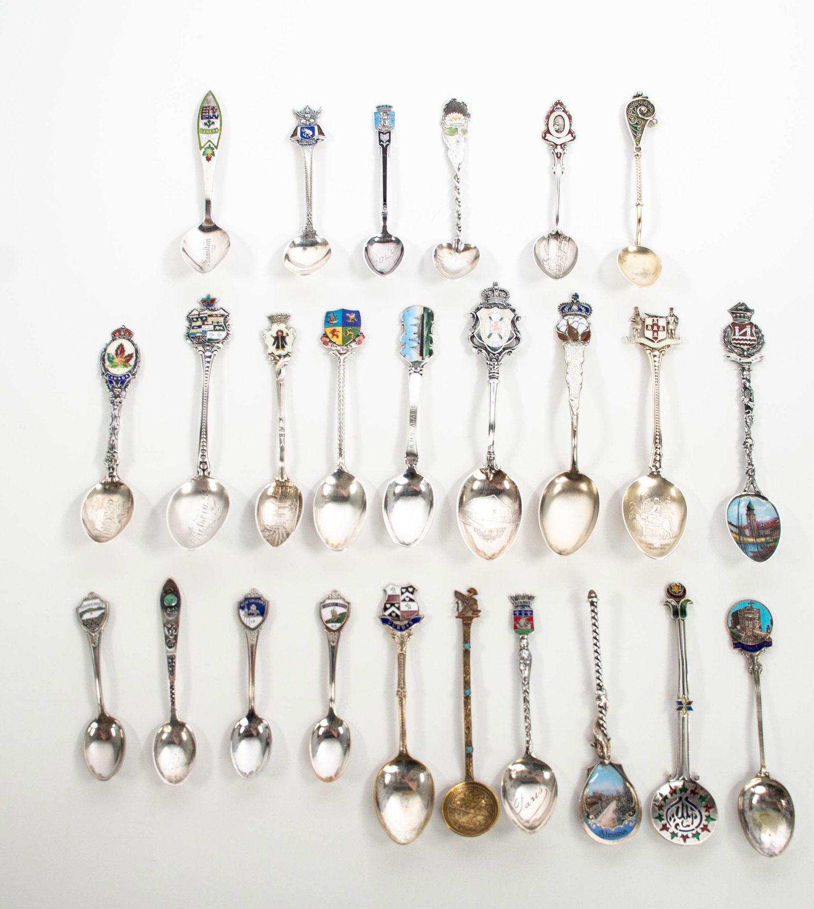 25 Enameled Souvenir & Other Spoons, Sterling: Qualifies for in-house shipping---15 enameled sterling and 800 silver spoons, mostly souvenir, and 10 other enameled spoons, comprising: 4 5/8" sterling White Star Line "R.M.S. Arabic"---4 3/8" gilt s
